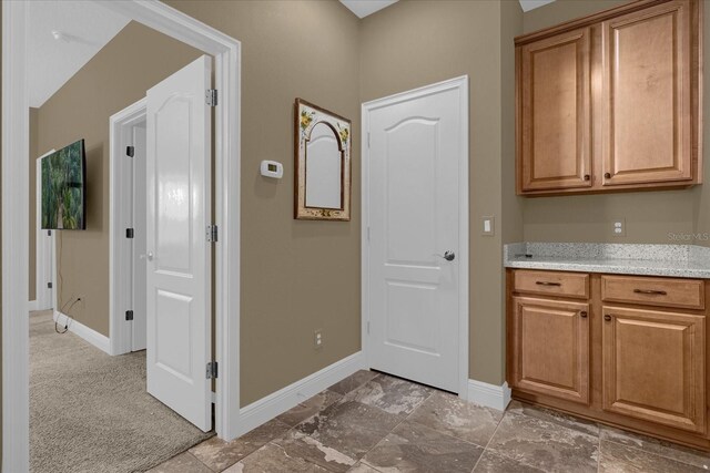 entryway featuring light colored carpet