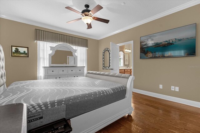 bedroom with ensuite bathroom, ceiling fan, dark hardwood / wood-style floors, and crown molding