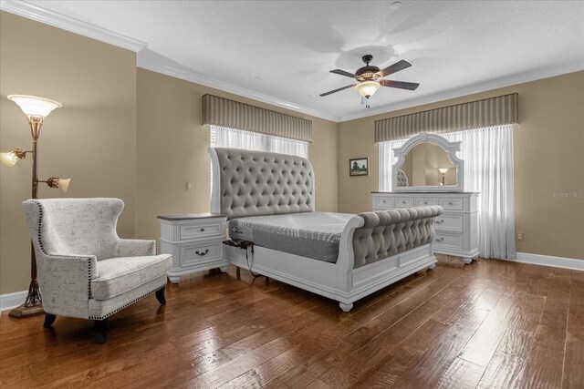 bedroom with ornamental molding, dark hardwood / wood-style flooring, ceiling fan, and multiple windows