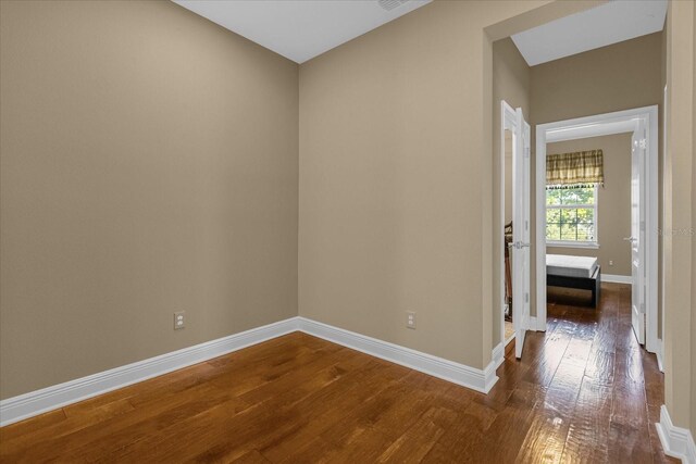 spare room with dark wood-type flooring