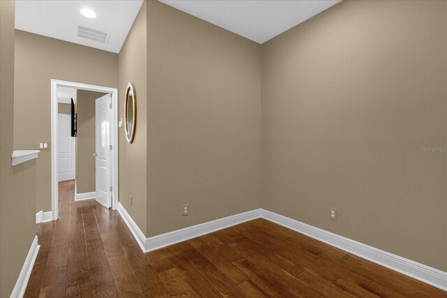 empty room featuring dark hardwood / wood-style flooring