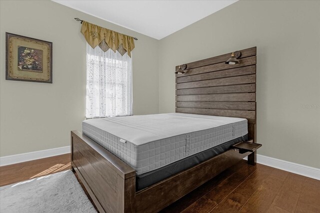 bedroom featuring dark hardwood / wood-style flooring