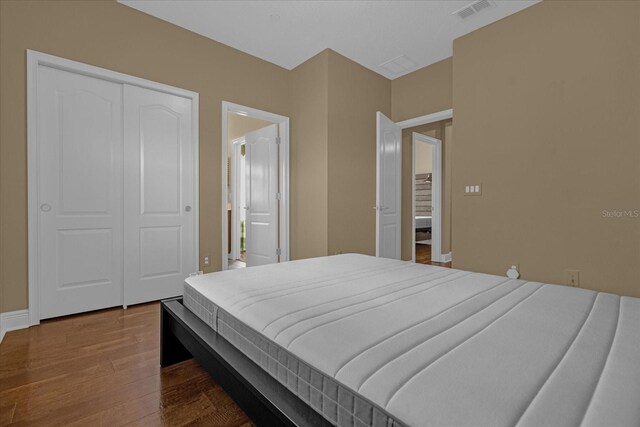 bedroom featuring a closet and dark hardwood / wood-style floors