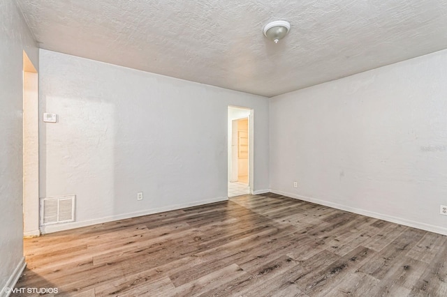 unfurnished room with hardwood / wood-style floors