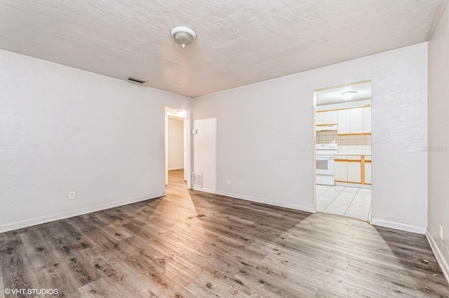 empty room featuring hardwood / wood-style flooring