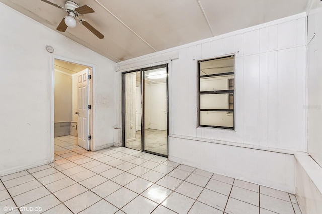 tiled spare room with ceiling fan and lofted ceiling