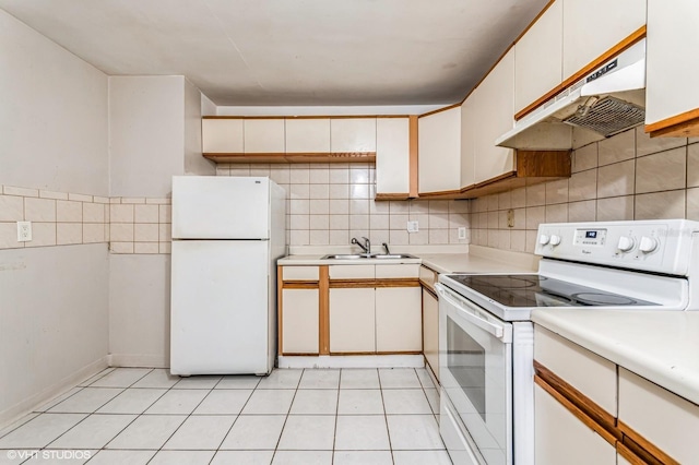 kitchen with white cabinetry, sink, light tile patterned floors, and white appliances