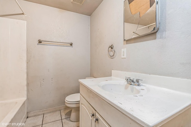 bathroom featuring tile patterned floors, vanity, and toilet