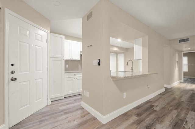 hall with sink and light hardwood / wood-style flooring