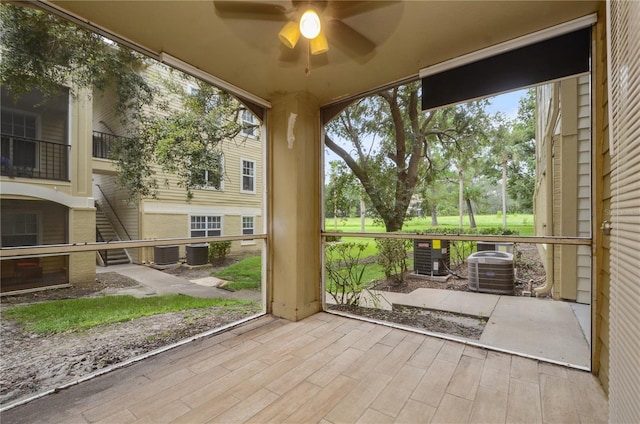 unfurnished sunroom featuring ceiling fan