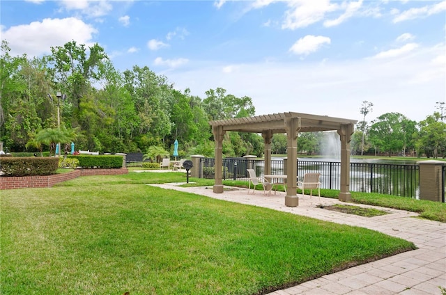 view of community with a yard, a pergola, and a water view