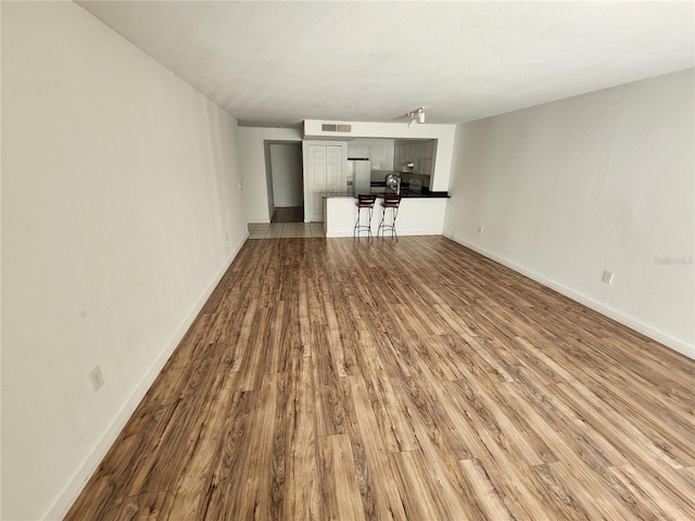 unfurnished living room featuring tile floors