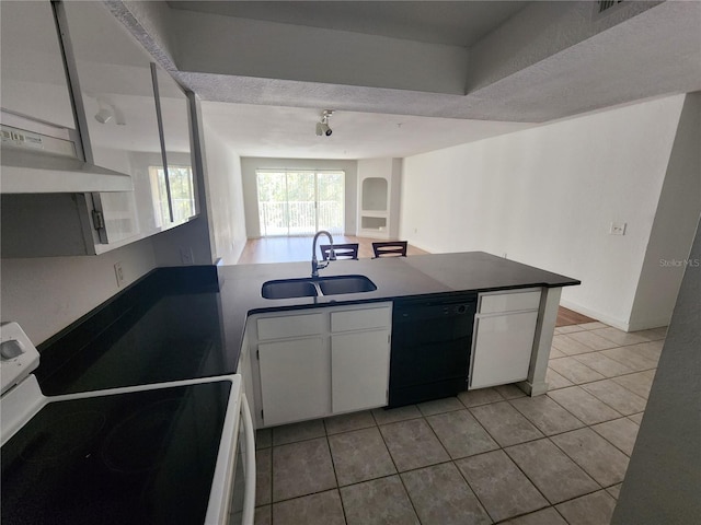 kitchen with black dishwasher, white stove, white cabinets, and sink