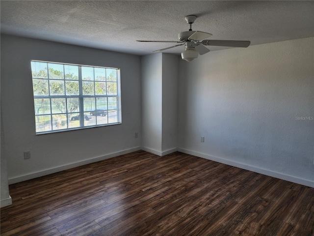 spare room with dark wood-type flooring, ceiling fan, and a textured ceiling