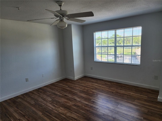 spare room with dark hardwood / wood-style floors, a textured ceiling, and ceiling fan