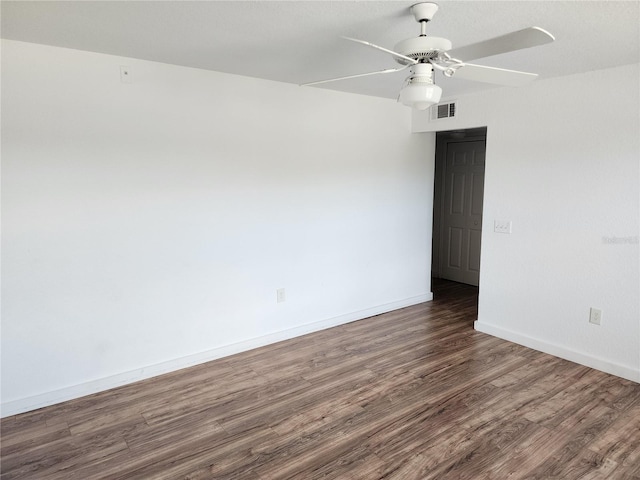 empty room with ceiling fan and dark wood-type flooring