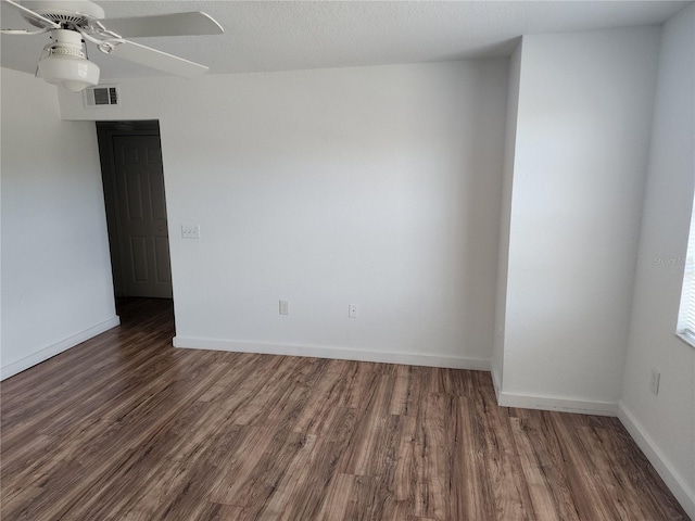 unfurnished room with dark hardwood / wood-style floors and ceiling fan