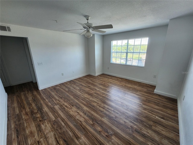 unfurnished room with a textured ceiling, ceiling fan, and dark wood-type flooring