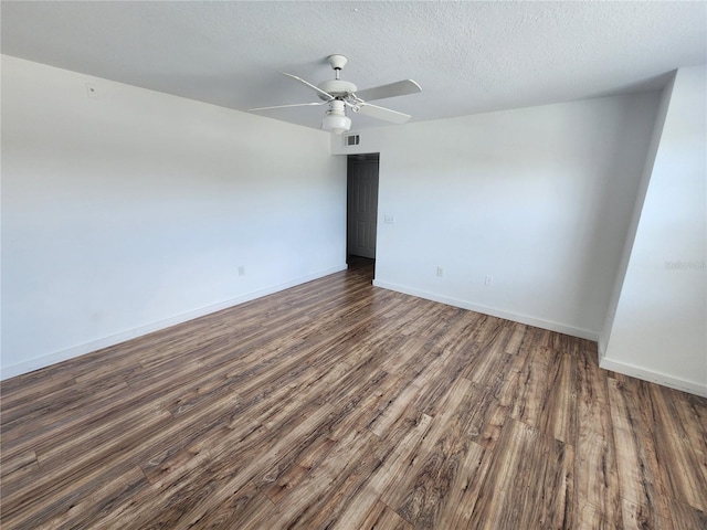 empty room featuring dark hardwood / wood-style floors, a textured ceiling, and ceiling fan