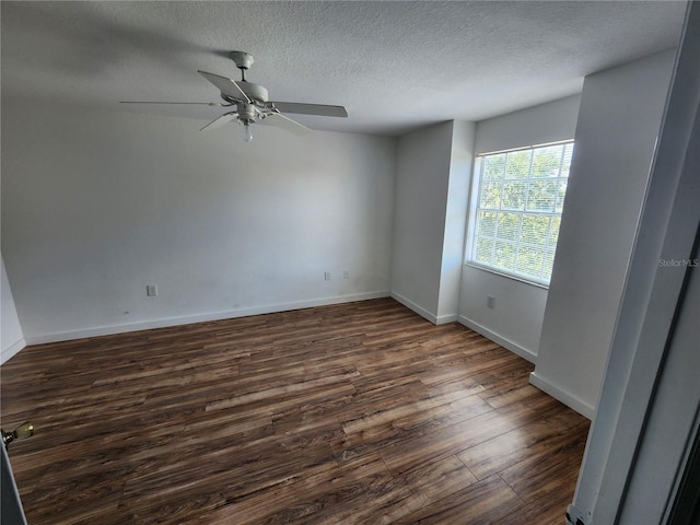 unfurnished room featuring ceiling fan, a textured ceiling, and dark wood-type flooring