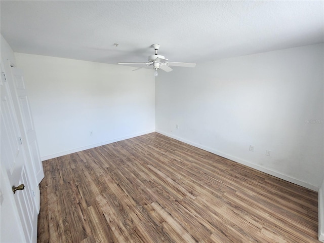 empty room with wood-type flooring and ceiling fan