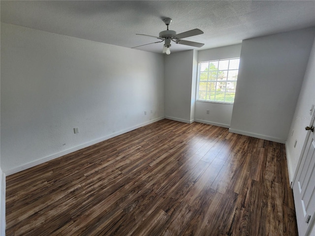 spare room with a textured ceiling, ceiling fan, and dark wood-type flooring