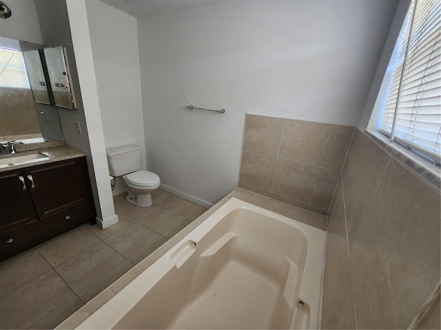 bathroom with vanity, toilet, a bathtub, and a wealth of natural light