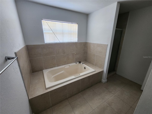 bathroom featuring plus walk in shower and tile flooring