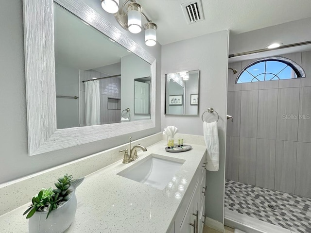 bathroom featuring a chandelier, curtained shower, and vanity