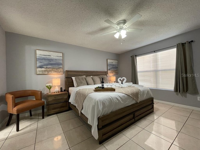 tiled bedroom featuring a textured ceiling and ceiling fan