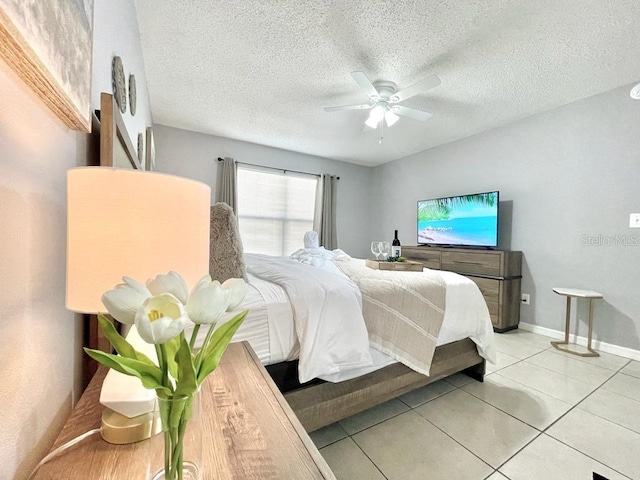 bedroom with light tile floors, a textured ceiling, and ceiling fan