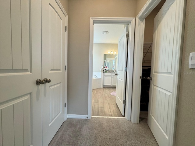 hallway with light hardwood / wood-style flooring