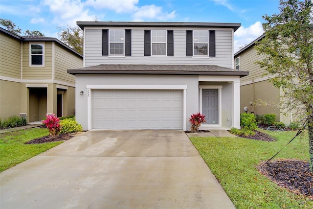 view of front property with a front lawn and a garage