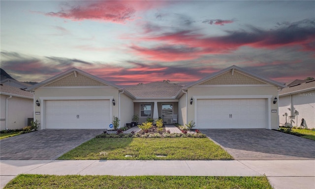 single story home with a garage and a yard