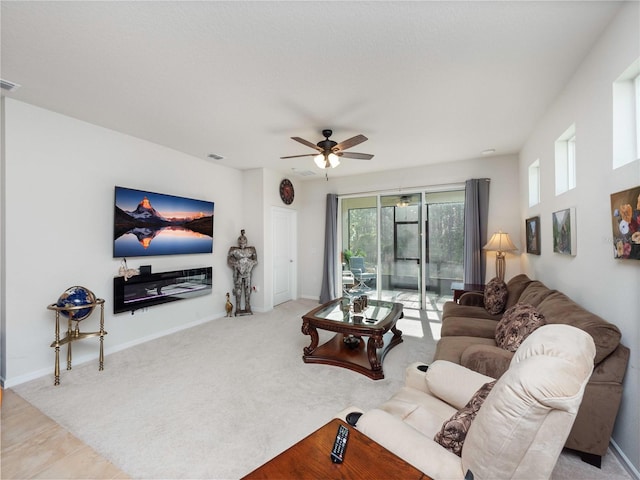 tiled living room featuring ceiling fan