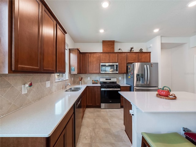 kitchen featuring stainless steel appliances, backsplash, light tile floors, a center island, and sink