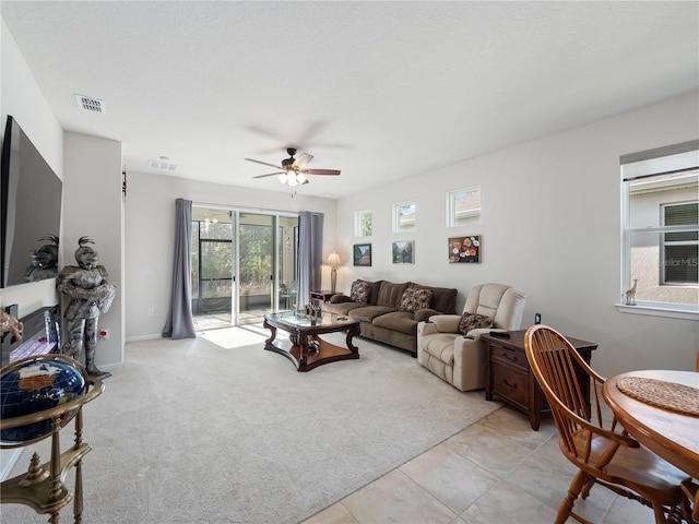 tiled living room featuring ceiling fan