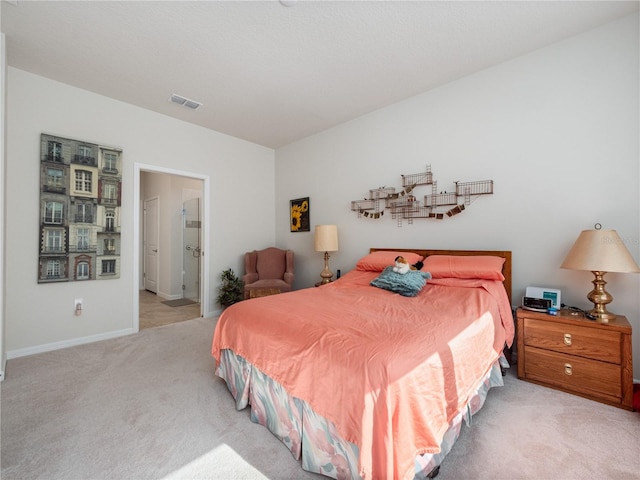 carpeted bedroom featuring ensuite bath