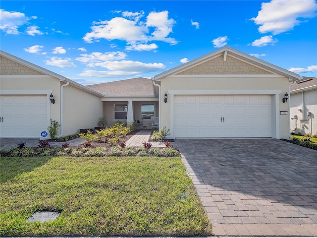 ranch-style home with a garage and a front yard