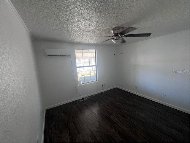 spare room featuring a wall unit AC, ceiling fan, a textured ceiling, and dark hardwood / wood-style flooring