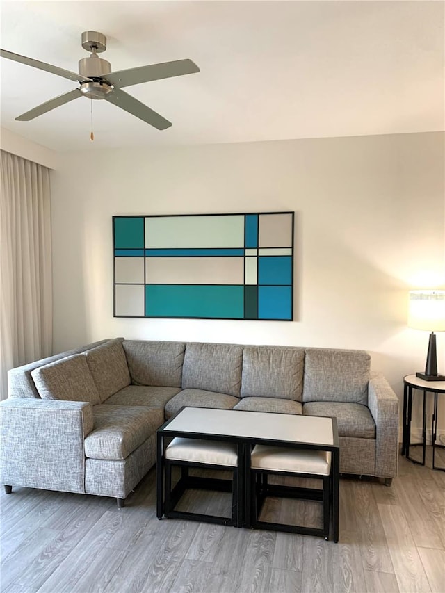 living room featuring ceiling fan and light wood-type flooring