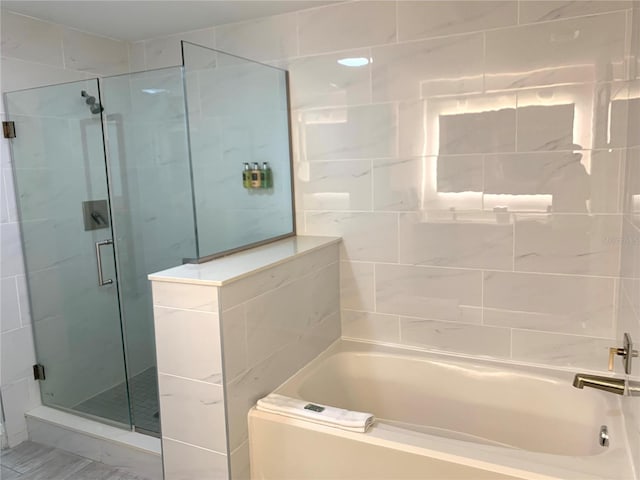 bathroom with separate shower and tub