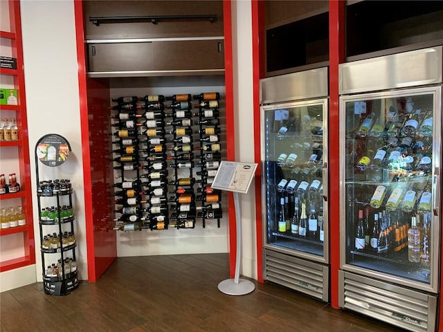 wine room with beverage cooler and dark hardwood / wood-style floors