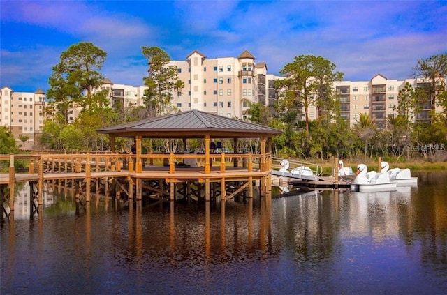 view of dock with a gazebo and a water view