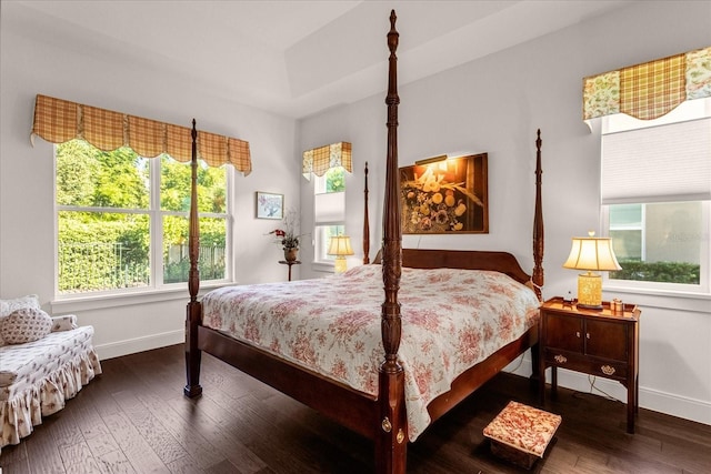 bedroom with dark wood-type flooring