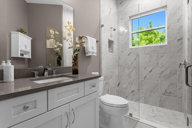 bathroom with a shower with shower door, toilet, and vanity