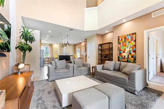 living room featuring a high ceiling and light tile flooring