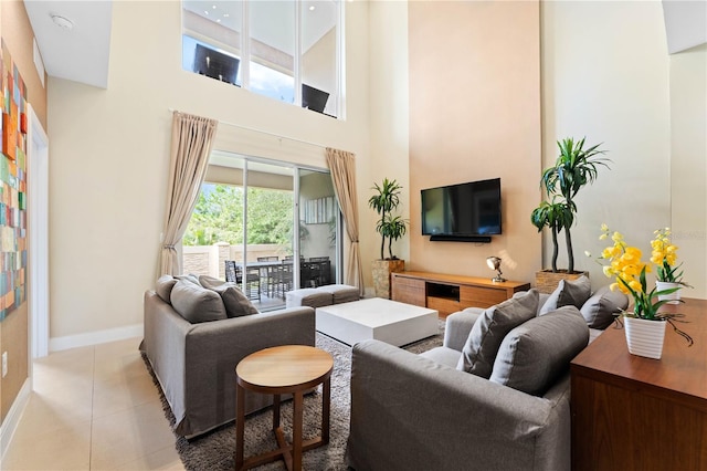 tiled living room featuring a high ceiling