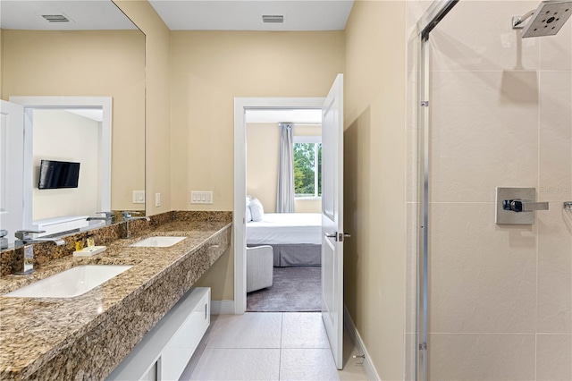 bathroom featuring a shower with door, tile flooring, oversized vanity, and dual sinks