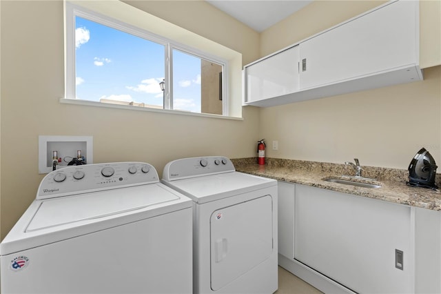 laundry room featuring washer hookup, washer and clothes dryer, cabinets, and sink